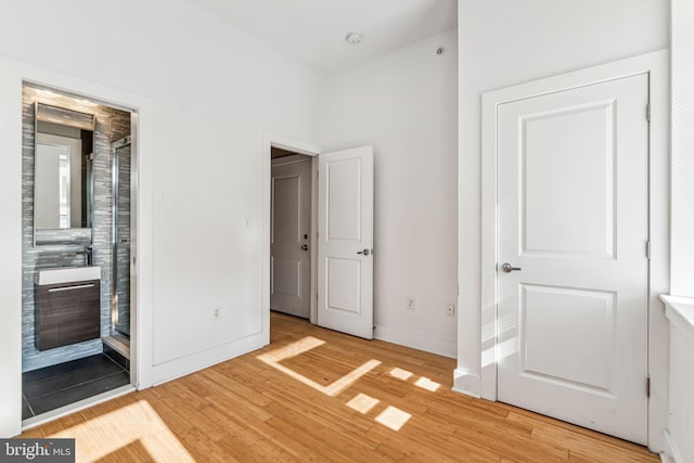 unfurnished bedroom with light wood-type flooring