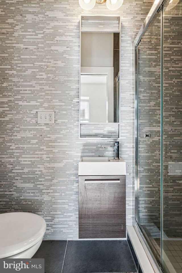 bathroom featuring tile walls, tile patterned floors, walk in shower, and toilet