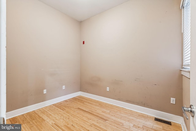 spare room featuring light hardwood / wood-style floors and a healthy amount of sunlight