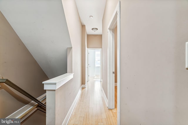 hallway with light hardwood / wood-style floors