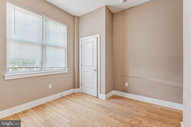 unfurnished room with light wood-type flooring