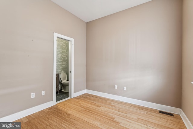 empty room with light hardwood / wood-style floors