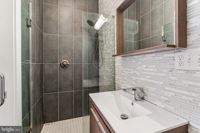 bathroom with decorative backsplash, a tile shower, vanity, and tile walls