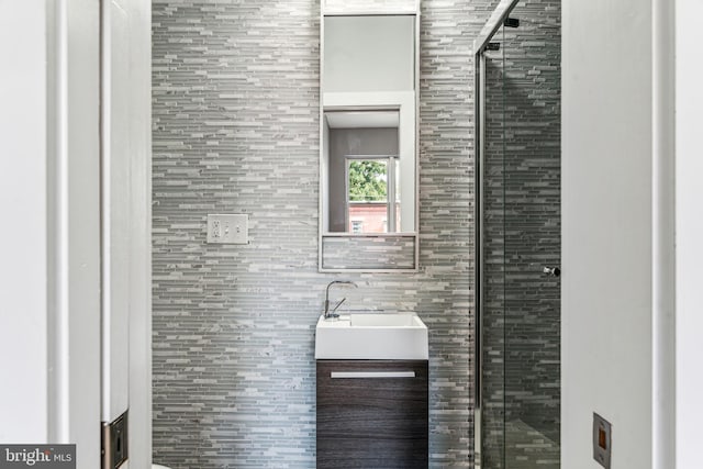 bathroom with walk in shower and vanity