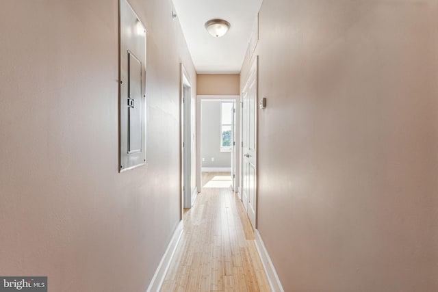 hallway with light hardwood / wood-style floors