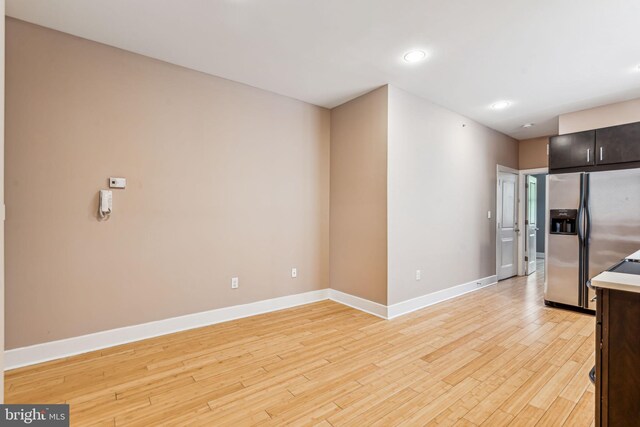 kitchen featuring light hardwood / wood-style flooring, dark brown cabinets, and stainless steel refrigerator with ice dispenser