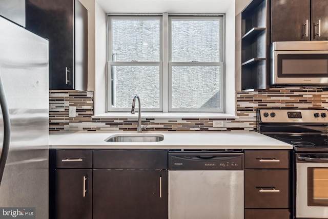 kitchen featuring sink, appliances with stainless steel finishes, and dark brown cabinets