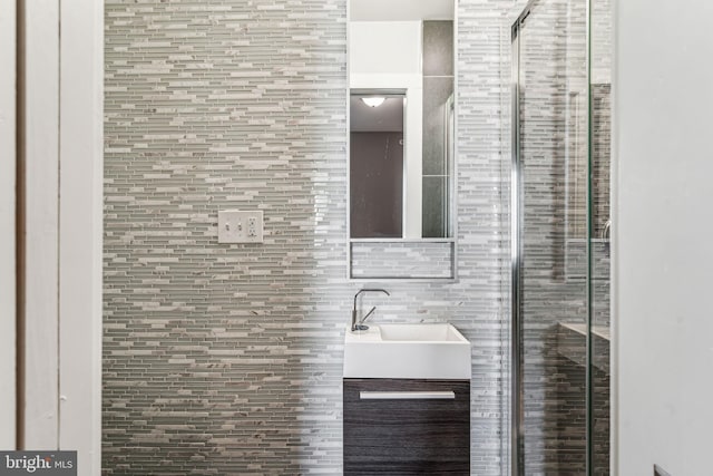 bathroom with tile walls and vanity