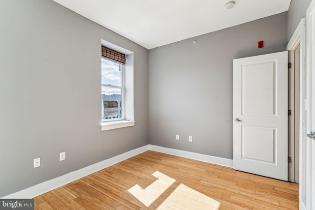 unfurnished room with light wood-type flooring