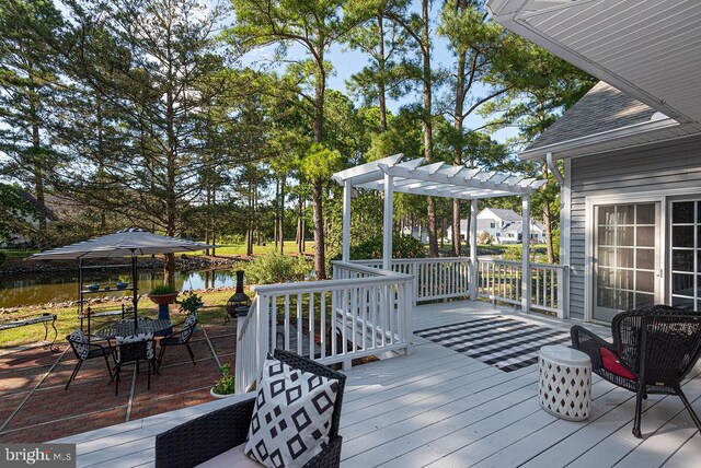 wooden terrace with a pergola and a water view