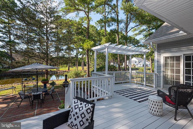 wooden terrace with a water view and a pergola