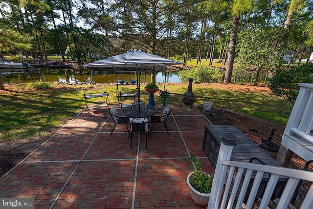 view of patio with a gazebo and a water view