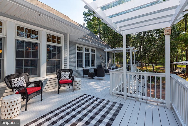 wooden terrace with an outdoor living space and a pergola