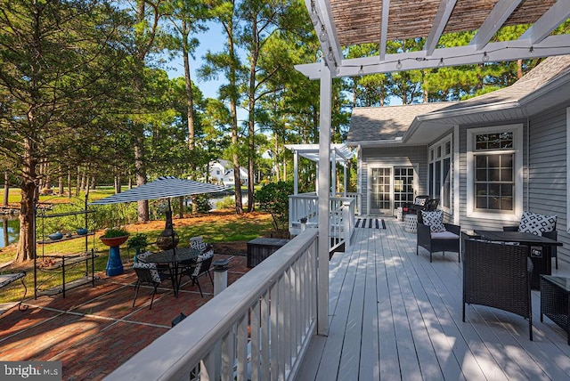 deck with a pergola and outdoor dining space