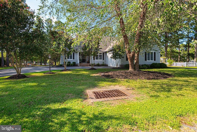 obstructed view of property featuring a front lawn