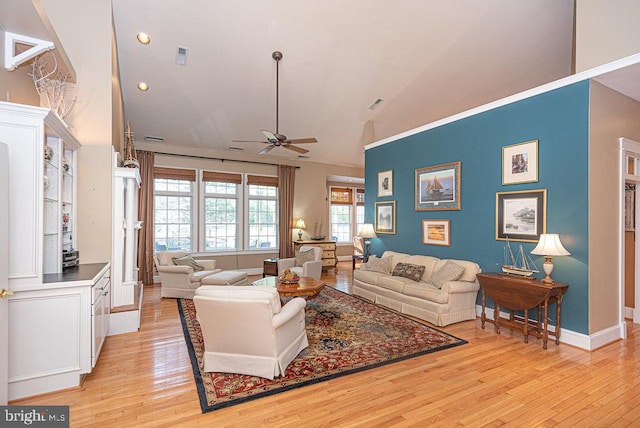 living room with ceiling fan, high vaulted ceiling, and light hardwood / wood-style flooring