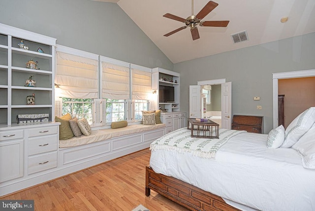 bedroom with light wood-type flooring, high vaulted ceiling, and ceiling fan