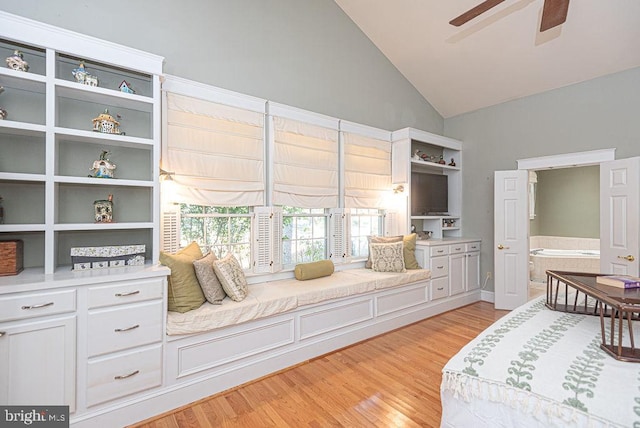 interior space with ceiling fan, high vaulted ceiling, and light hardwood / wood-style flooring