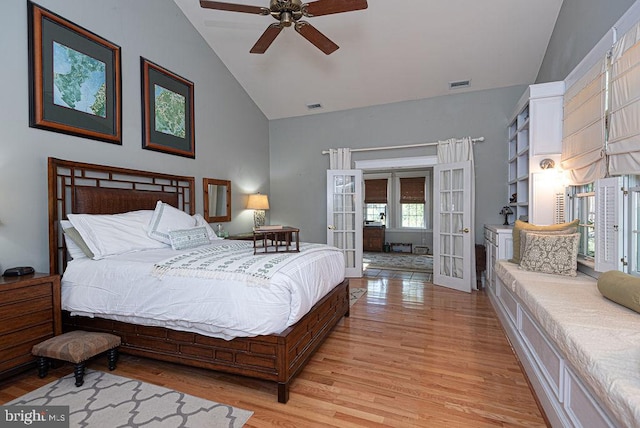 bedroom with high vaulted ceiling, light wood-style flooring, visible vents, and french doors