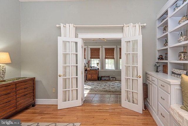 interior space featuring light wood-type flooring and french doors