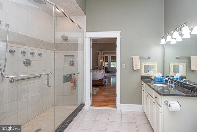 bathroom featuring hardwood / wood-style flooring, walk in shower, and vanity