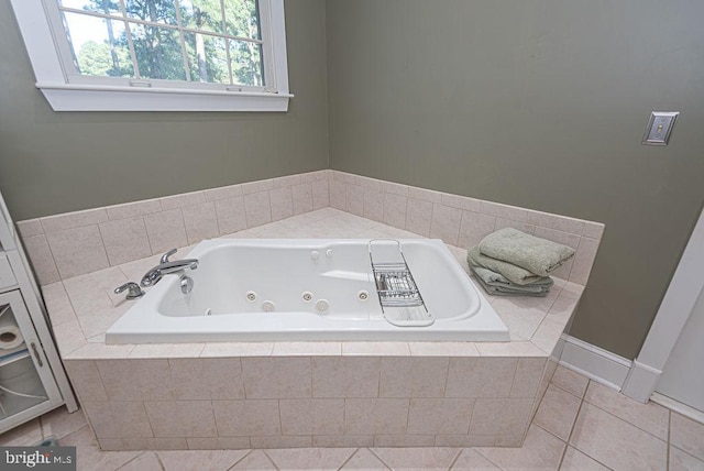 bathroom with tile patterned floors and a relaxing tiled tub