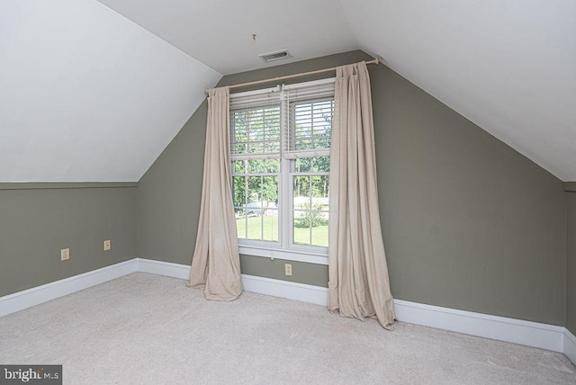 bonus room featuring light carpet, vaulted ceiling, visible vents, and baseboards