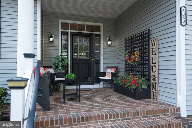 doorway to property featuring covered porch