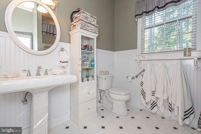 bathroom featuring toilet and tile patterned floors