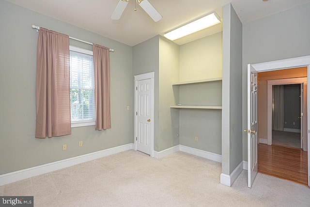 unfurnished bedroom with baseboards, a closet, and light colored carpet