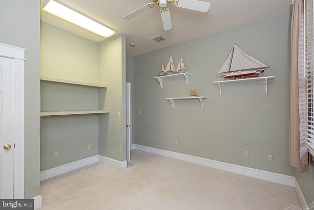 unfurnished bedroom featuring light carpet, ceiling fan, visible vents, and baseboards