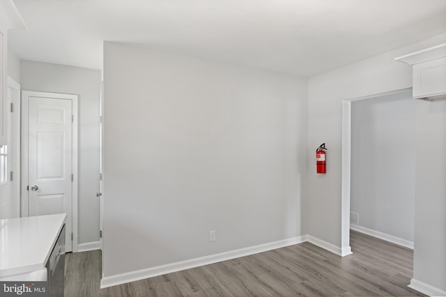 interior space with baseboards and wood finished floors