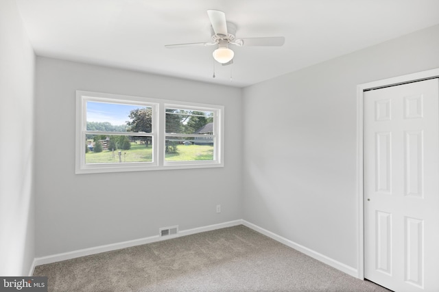 spare room featuring carpet floors and ceiling fan