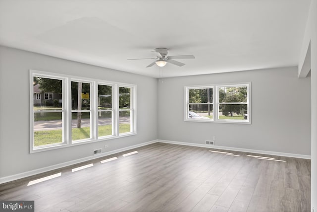 empty room featuring hardwood / wood-style flooring and ceiling fan