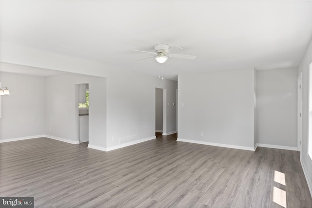 empty room with light wood-type flooring, baseboards, visible vents, and ceiling fan