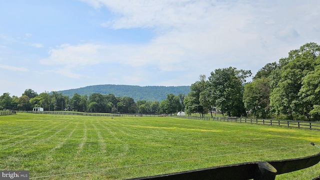 mountain view with a rural view and a view of trees