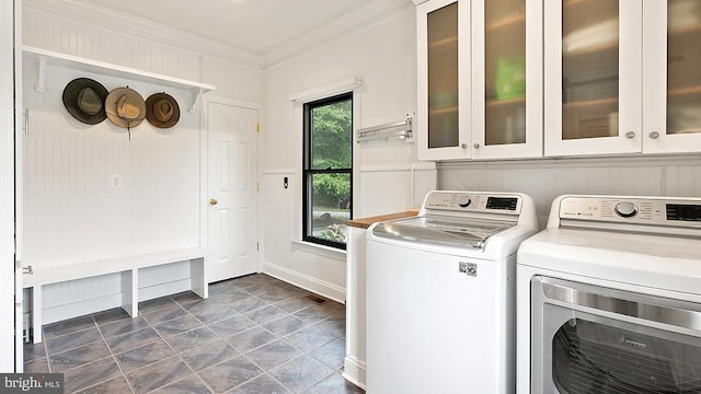 laundry room featuring cabinet space, separate washer and dryer, and crown molding