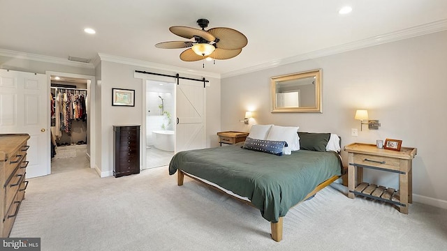 bedroom featuring wine cooler, light colored carpet, a spacious closet, a barn door, and baseboards