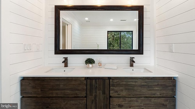 bathroom with double vanity, a sink, and recessed lighting