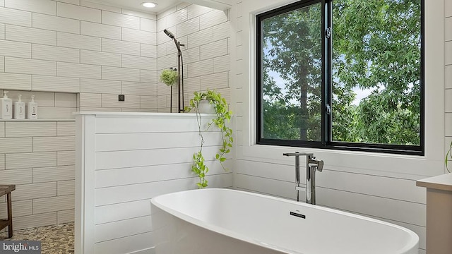 bathroom featuring a soaking tub, a tile shower, and recessed lighting