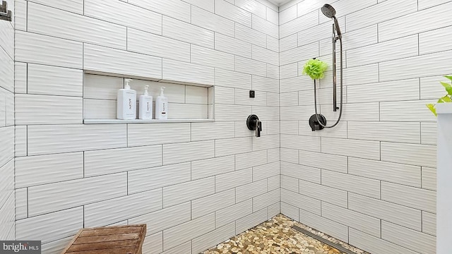 bathroom with tiled shower