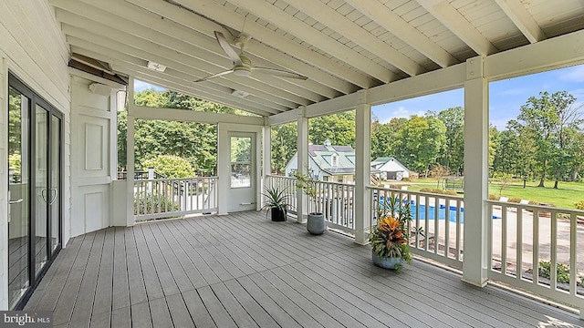 unfurnished sunroom featuring lofted ceiling and ceiling fan