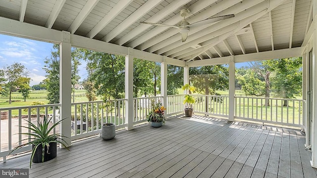 unfurnished sunroom with lofted ceiling with beams and ceiling fan