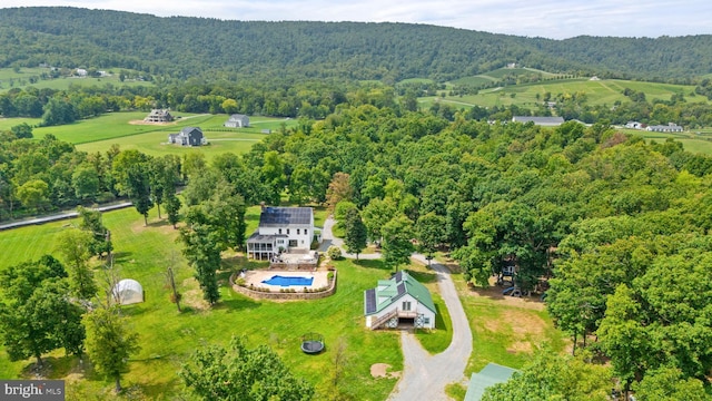 birds eye view of property with a wooded view