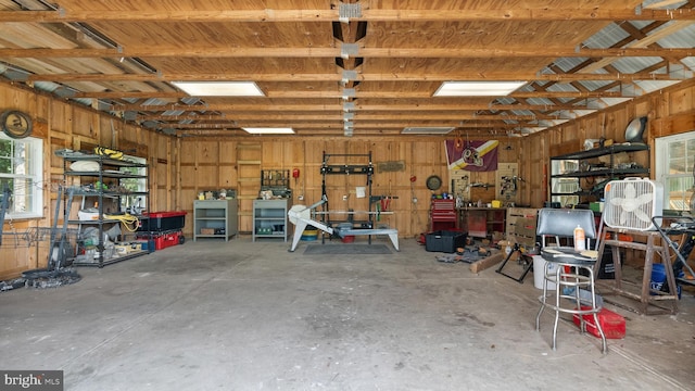 garage featuring a workshop area and metal wall