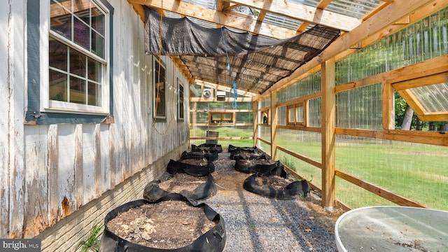 sunroom featuring vaulted ceiling