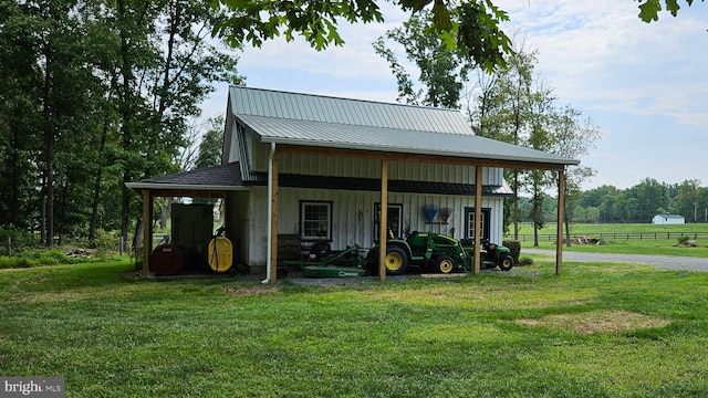 exterior space with a carport, a lawn, and driveway