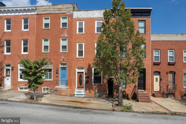 view of front of house with entry steps and brick siding