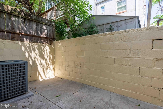 exterior space featuring cooling unit and fence