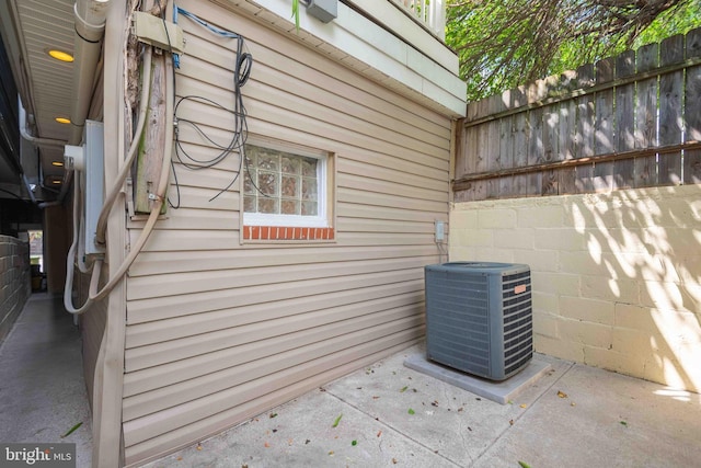 exterior details with central AC and fence